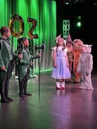 a group of people dressed up in costumes on a stage