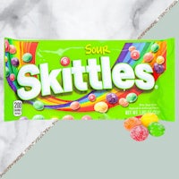 a bag of skittles on a marble table