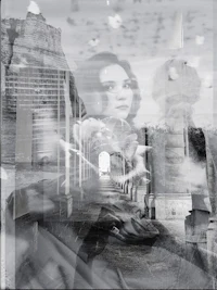 a black and white photo of a woman on a bridge