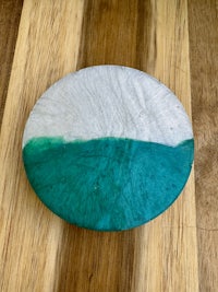 a green and white plate on a wooden table