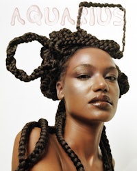 a black woman with braids on her head