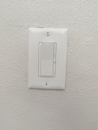 a light switch on a white wall