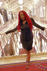 a woman with red hair standing on a balcony