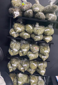 many bags of marijuana are sitting on a shelf