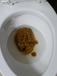 a toilet with a brown substance in it
