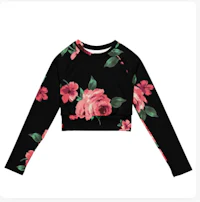 a black long sleeved crop top with pink flowers on it