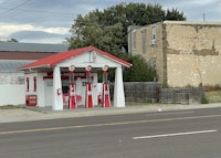 a gas station on the side of the road