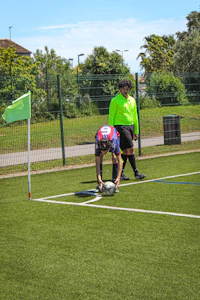 a man bending down to pick up a ball