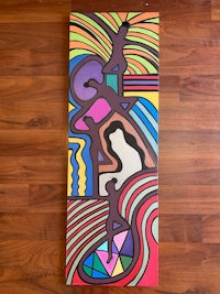 a colorful abstract painting on a wooden floor