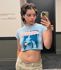 a woman is taking a selfie in a mirror