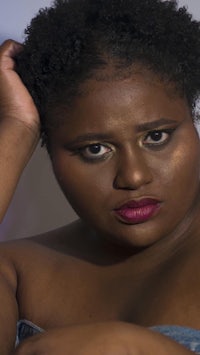 a woman with afro hair posing for a photo