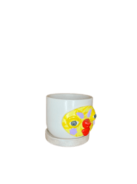 a white cup with a clown face on it