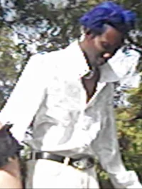 a man in a white shirt with blue hair