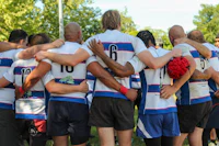 a group of rugby players in a huddle