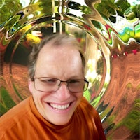 a man smiling in front of a mirror