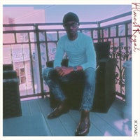 a man sitting on a chair on a balcony