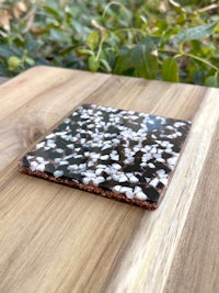a black and white coaster on top of a wooden table