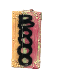a pink and yellow book with graffiti on it
