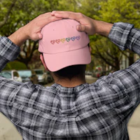 a man wearing a pink hat with hearts on it