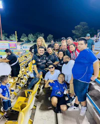 a group of people posing for a photo in a stadium