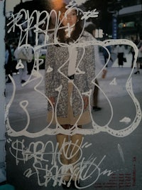 a poster of a woman with graffiti on it