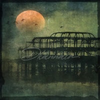 an image of a pier with a full moon in the background