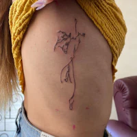 a tattoo of a woman with a line drawn on her ribcage
