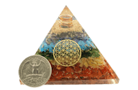 a pyramid with a coin next to it