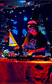 a dj is playing music at a table