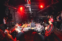 a group of people at a night club with djs