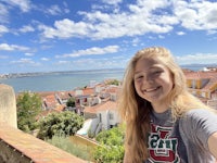 a girl is taking a selfie in front of a building