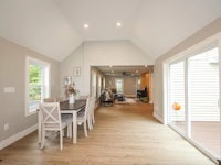 a dining room with hardwood floors and a sliding glass door