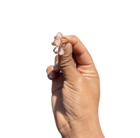 a person's hand holding a small earring