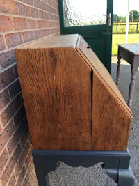a wooden desk with a drawer on it