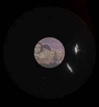 a black lp with a picture of people on it
