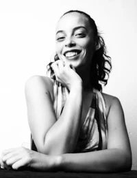 a black and white photo of a woman smiling