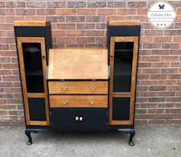 a black and wood desk with drawers and doors