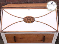 a white desk with an ornate design on it