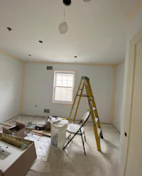 a room being remodeled with a ladder and paint