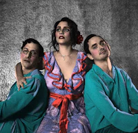 three women in costumes posing for a photo
