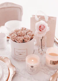a table setting with candles and roses