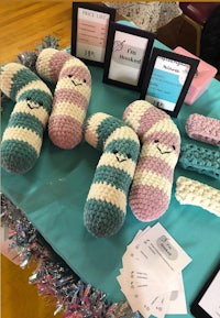 a table with crocheted stuffed animals on it