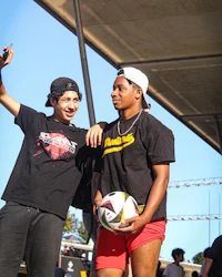 two young men taking a selfie with a soccer ball