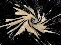 a black and gold swirl on a black background