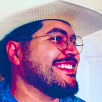 a man wearing a cowboy hat and glasses