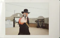 a man in a cowboy hat holding a gun