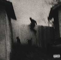 a black and white photo of a man jumping over a fence