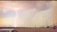 a car in the rain with a lightning bolt in the sky