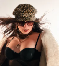 a woman wearing a leopard print hat