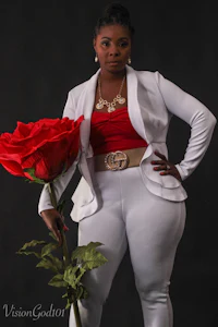 a woman in white pants and a red rose